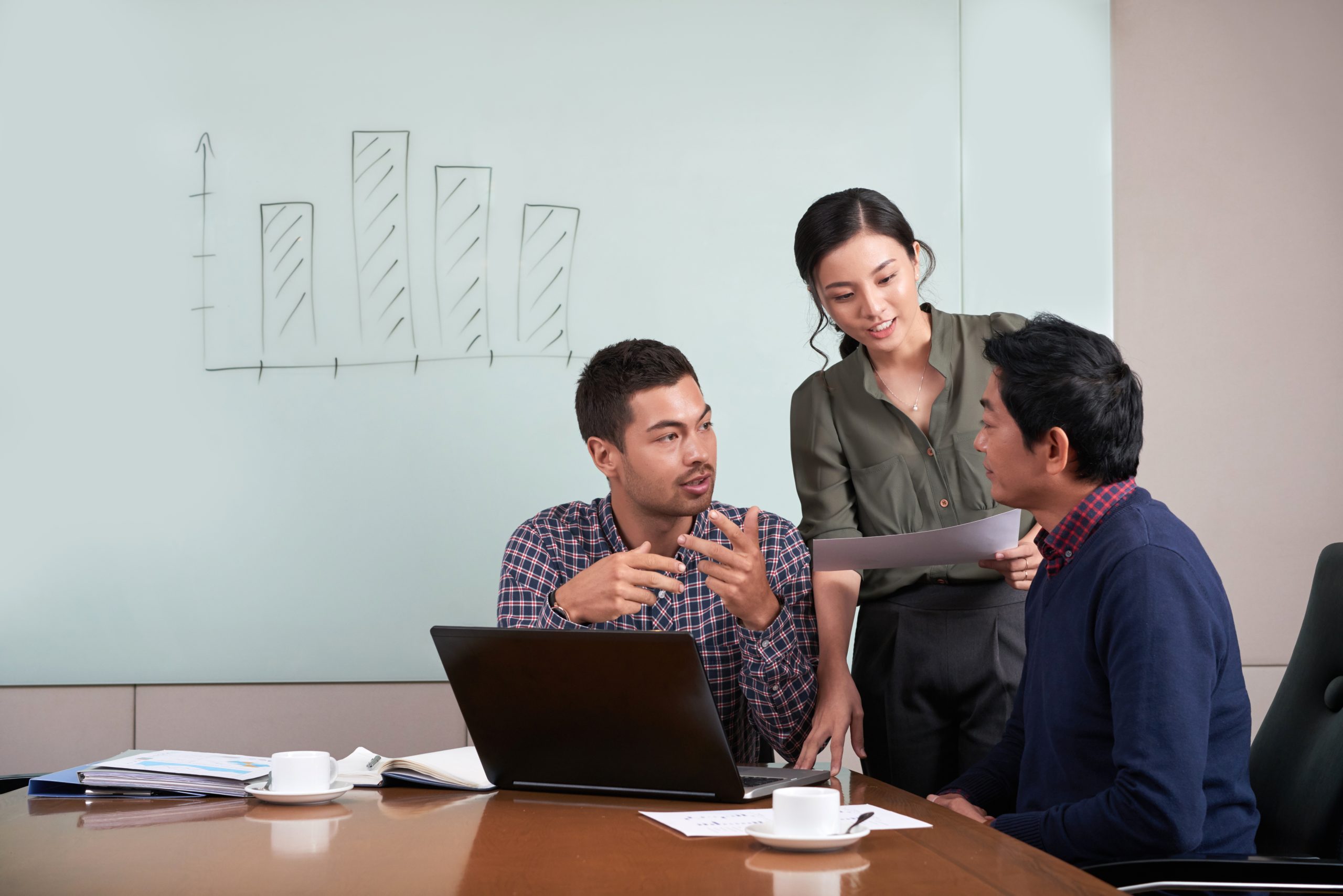Group of young coworkers discussing project together